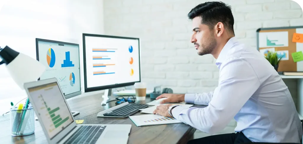 side-view-young-attractive-businessman-studying-charts-computer-while-working-home